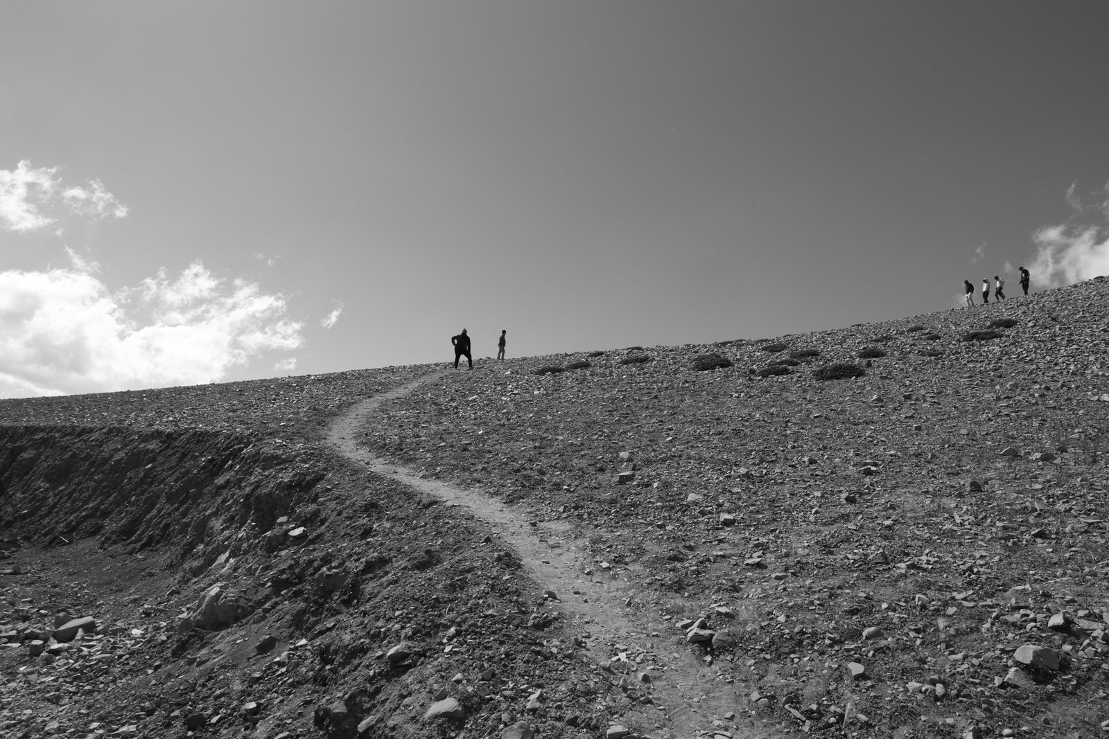 People hiking on rocky mountain terrain.jpg